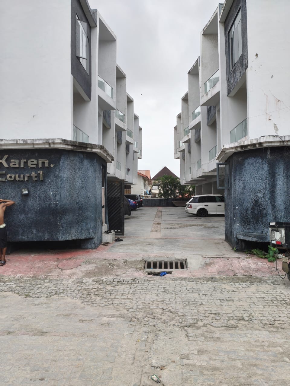 The approach: estate gate and driveway from the street